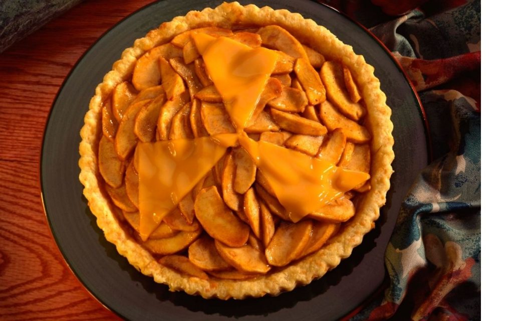 Apple pie with cheddar cheese sits out ready to eat