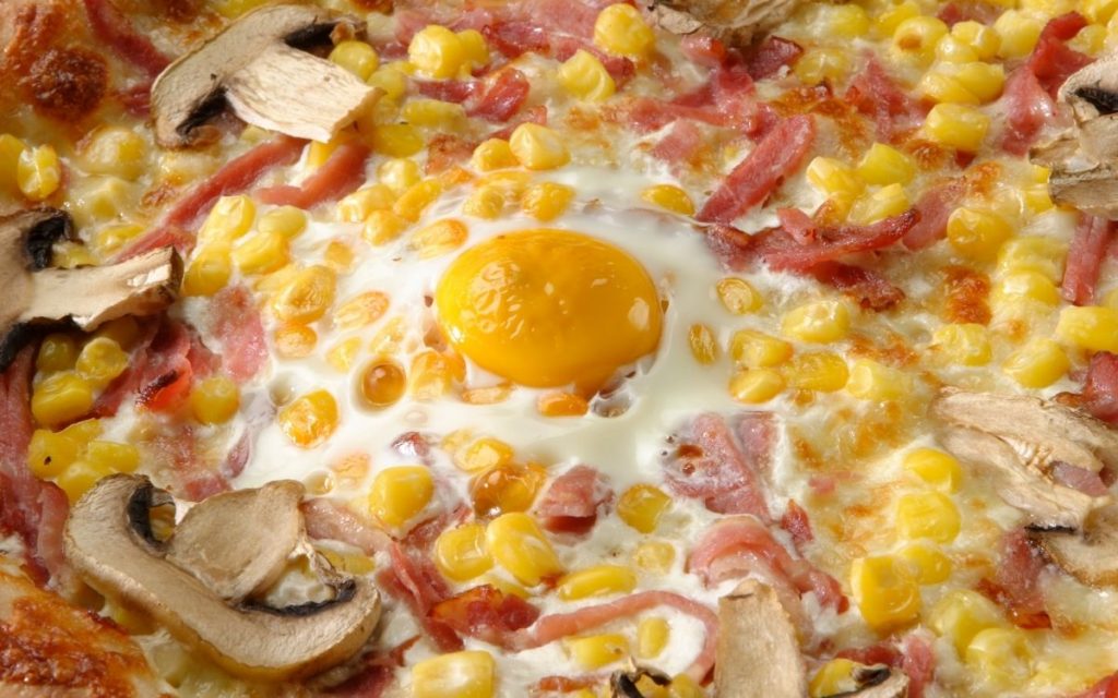 Over easy egg baked into a pizza.