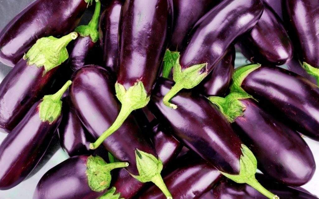 Pile of multiple eggplants.