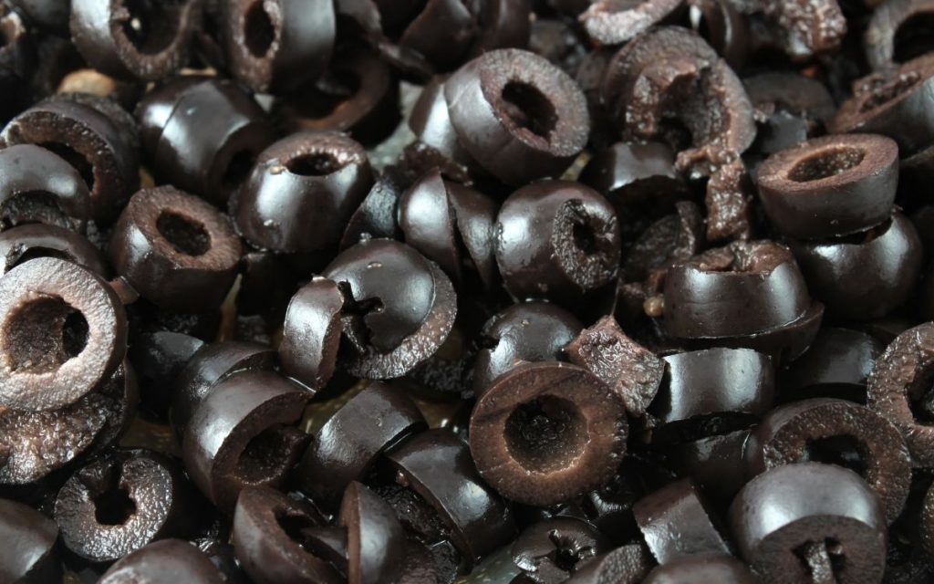A close up shot of sliced black olives.