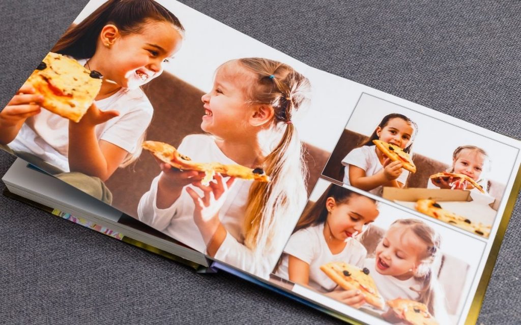 A photo album book of young girls eating pizza.