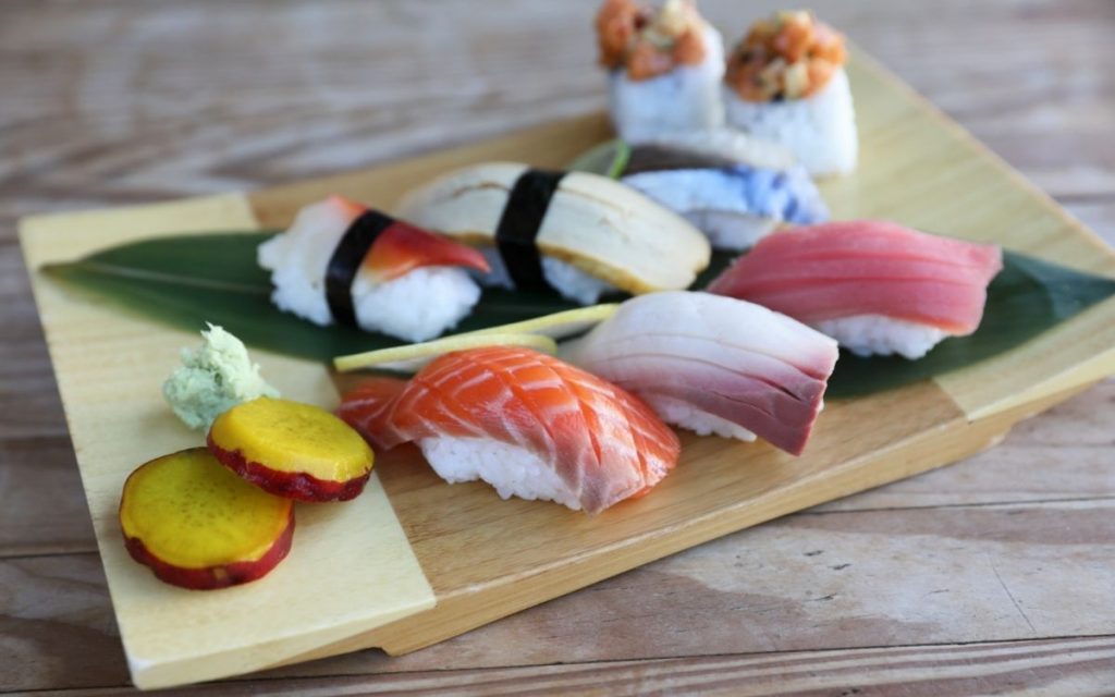 Raw sushi choices on a cutting board.