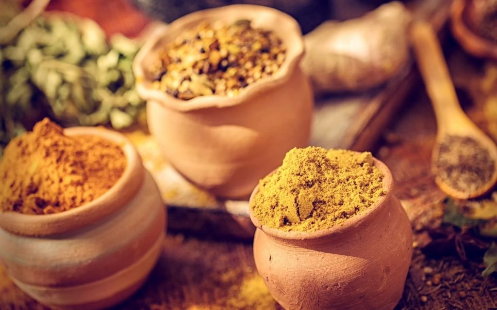 Various spices sit in their own hand made clay bowl.