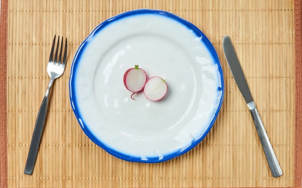 Radish cut and half on a plate.