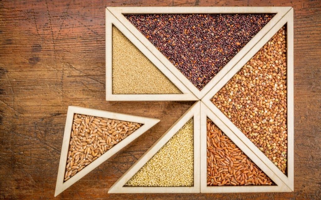 An assortment of wheat free nuts each in their own triangle shaped dish.