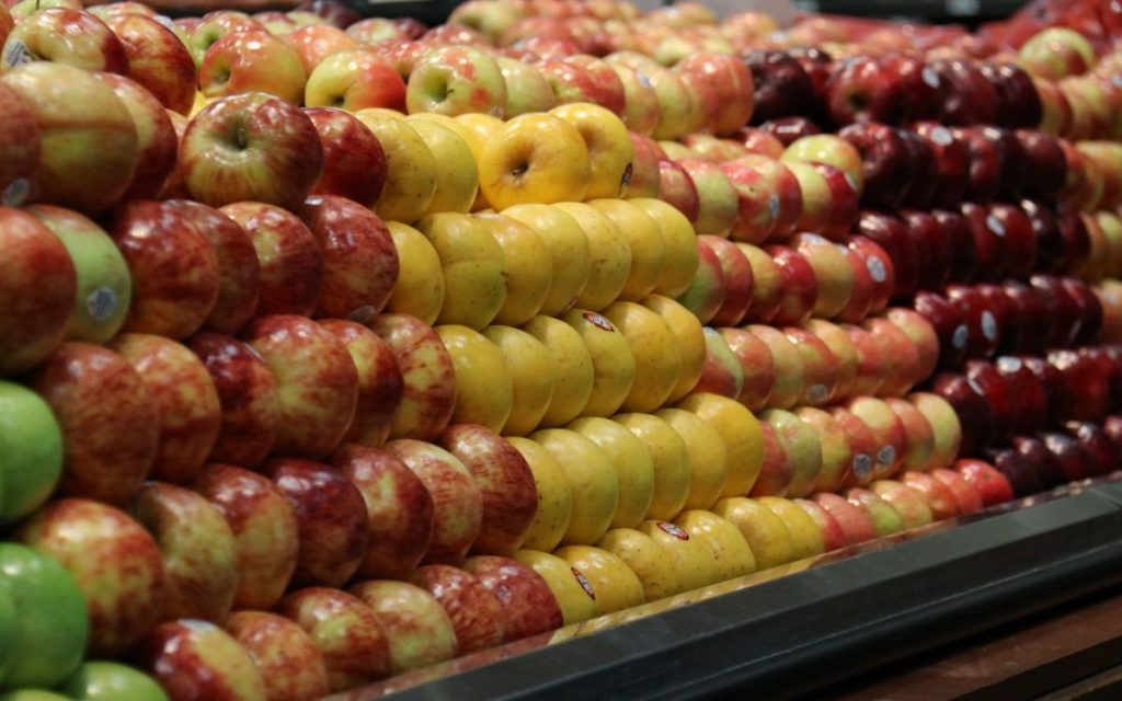 Apples stacked in a grocery store.