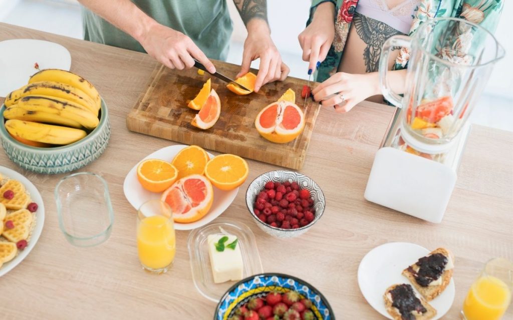 couple cutting fruit for a healthy breakfast